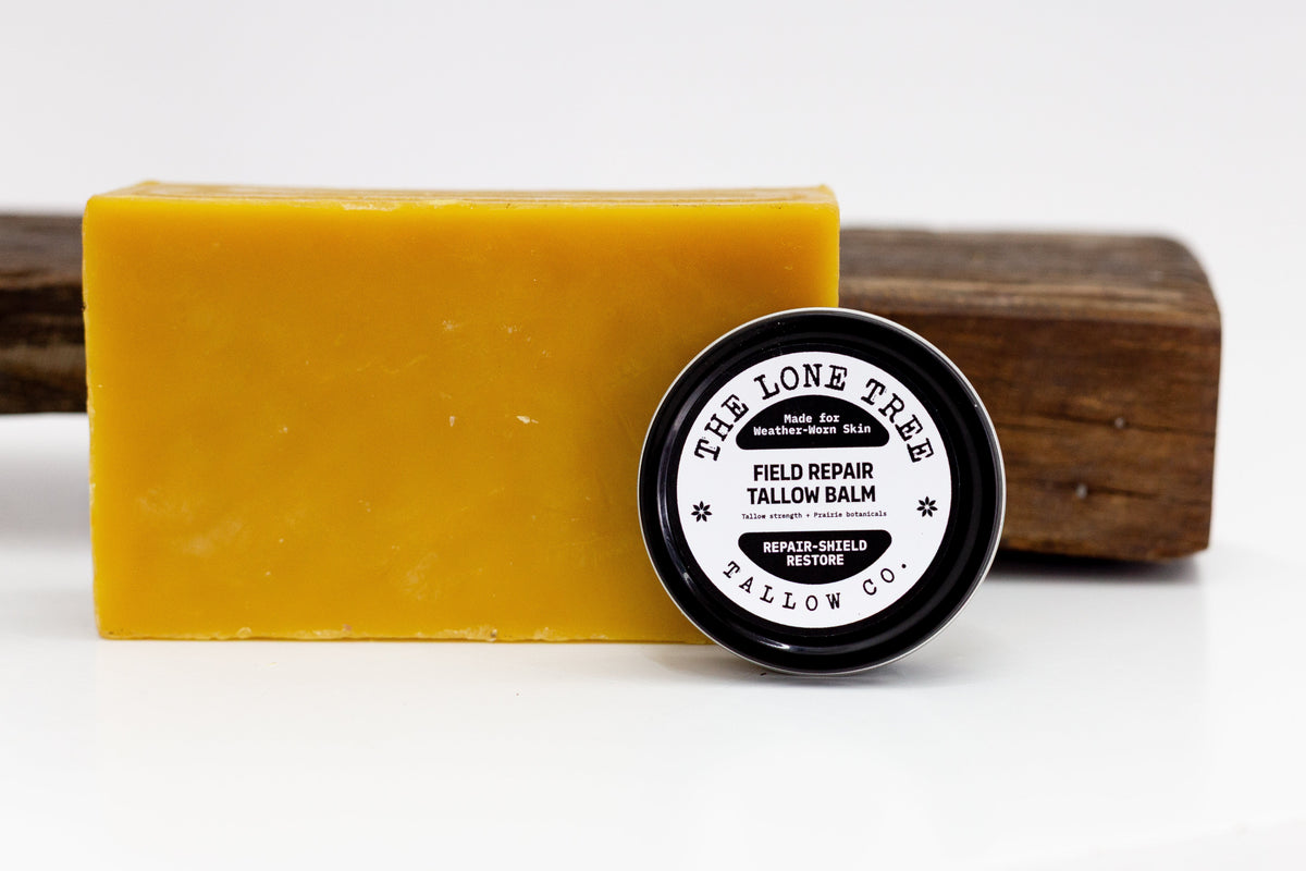 Field Repair Tallow Balm tin beside a block of local beeswax