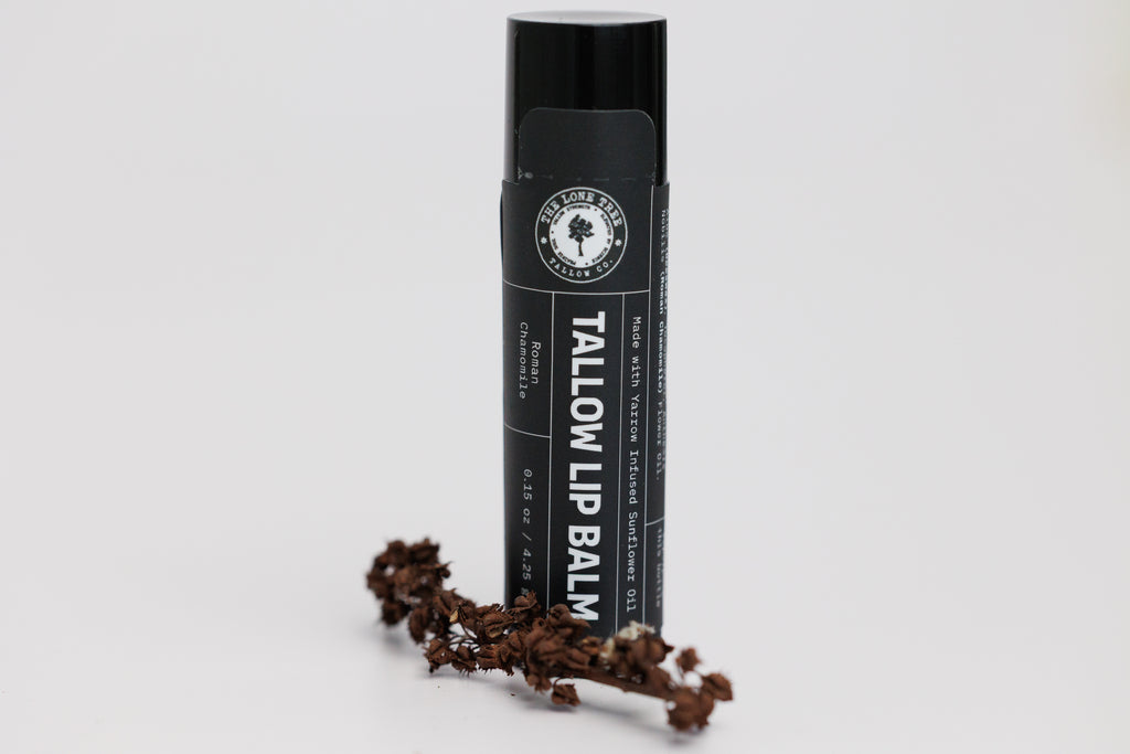 Lone Tree Tallow Co. Wild Yarrow infused sunflower oil and heritage tallow lip  balm in roman chamomile comes in a black bpa free container. handcrafted in small batches on the prairie by a chemist. 
