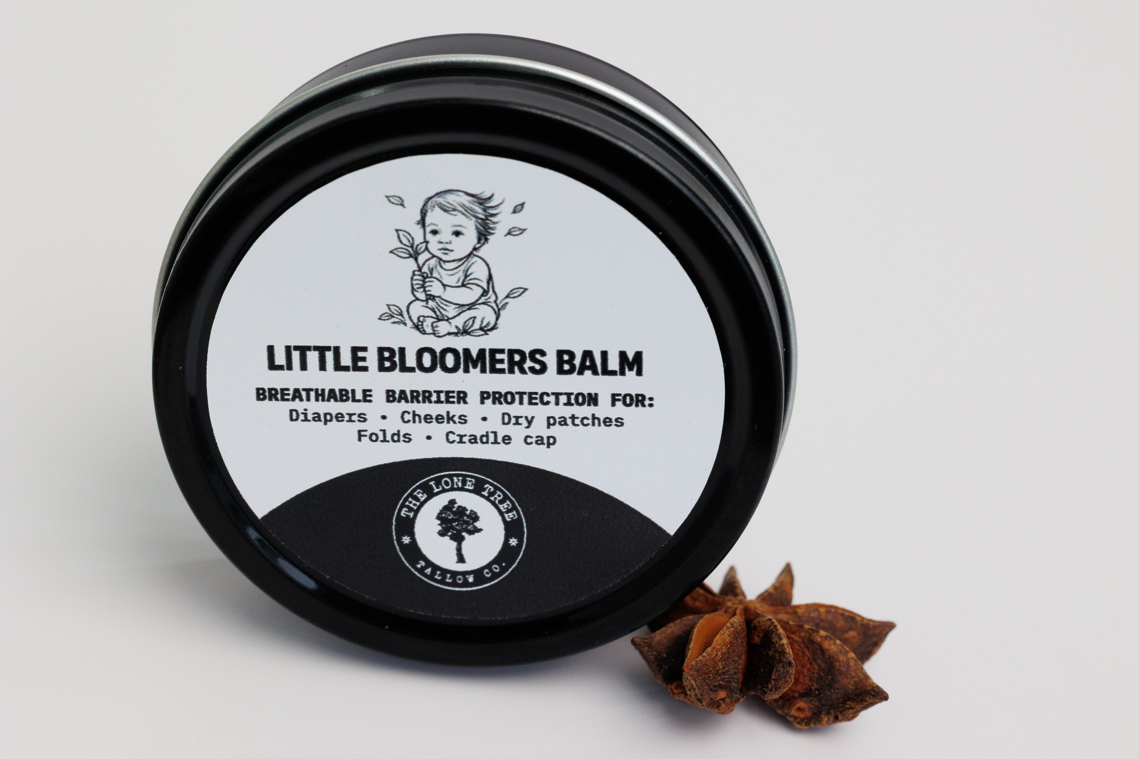 Little Bloomers Balm from Lone Tree Tallow Co. in a 2 oz black tin. used for diapers, cradle cap and dry patches. safe for babies. pure heritage tallow, calendula infused sunflower oil, vitamin E. no essential oils. pure and natural. 