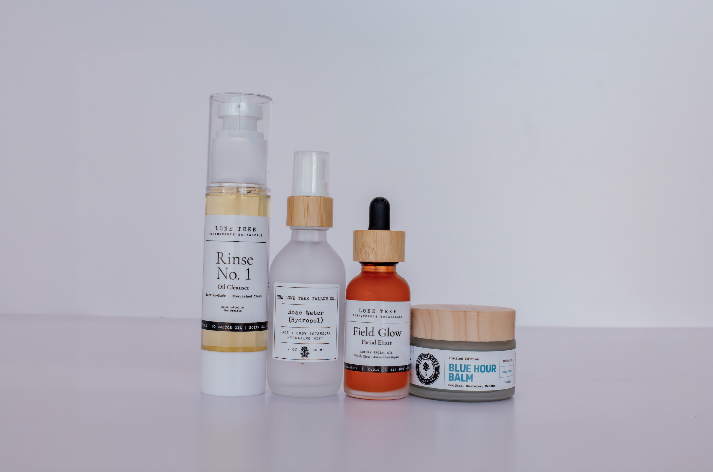 Lone Tree Tallow Blue Horizon ritual skincare set is perfect for hormonal, perimenopausal, menopausal skin. It contains Rinse No.1 barrier safe oil cleanser, rose water hydrosol or cactus water hydrolat, field glow luxury facial oil with astaxanthin and teprenone, and blue hour tallow face balm with bakuchiol and blue tansy. 