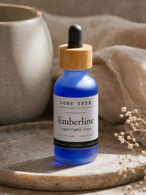 Emberline Copper Peptide Serum by Lone Tree Performance Botanicals, cobalt blue glass dropper bottle on a stone tray